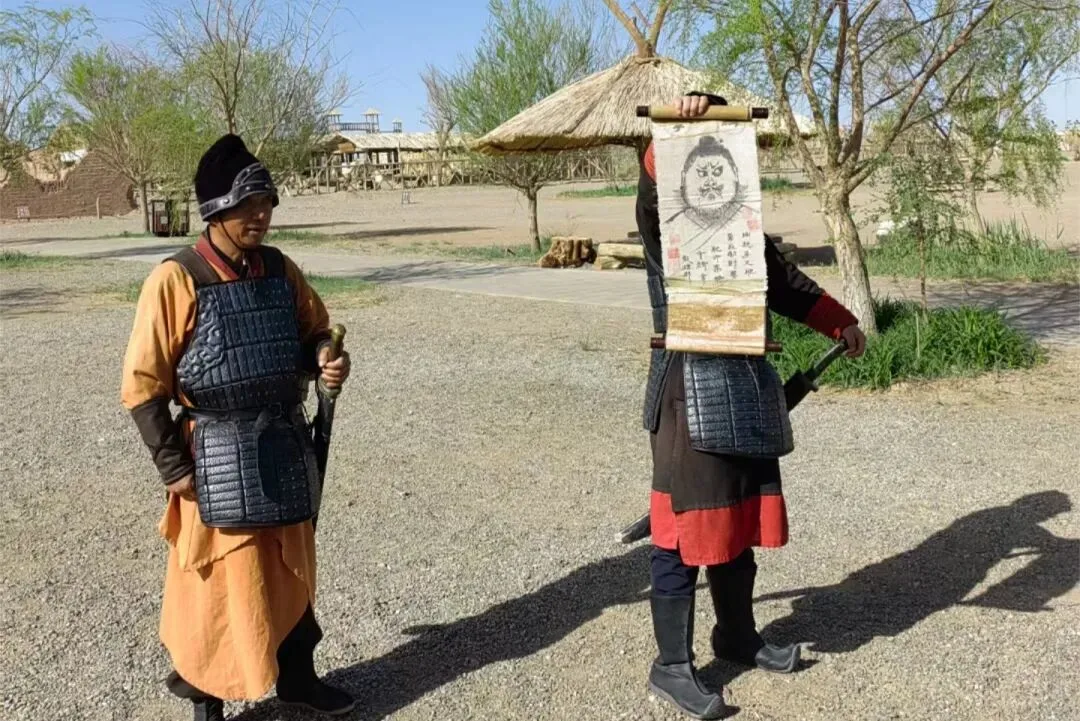 Two costumed guards in lamellar armour, one holding up an inked scroll pass