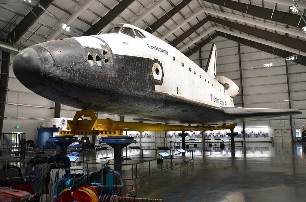 The Space Shuttle Endeavour mounted on its cradle in a hangar display hall.