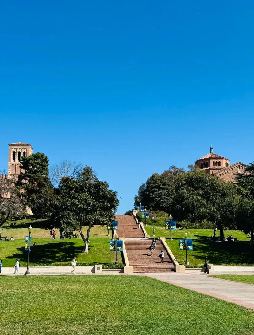 The wide brick campus steps at UCLA, lined with Go Bruins banners and lawns.