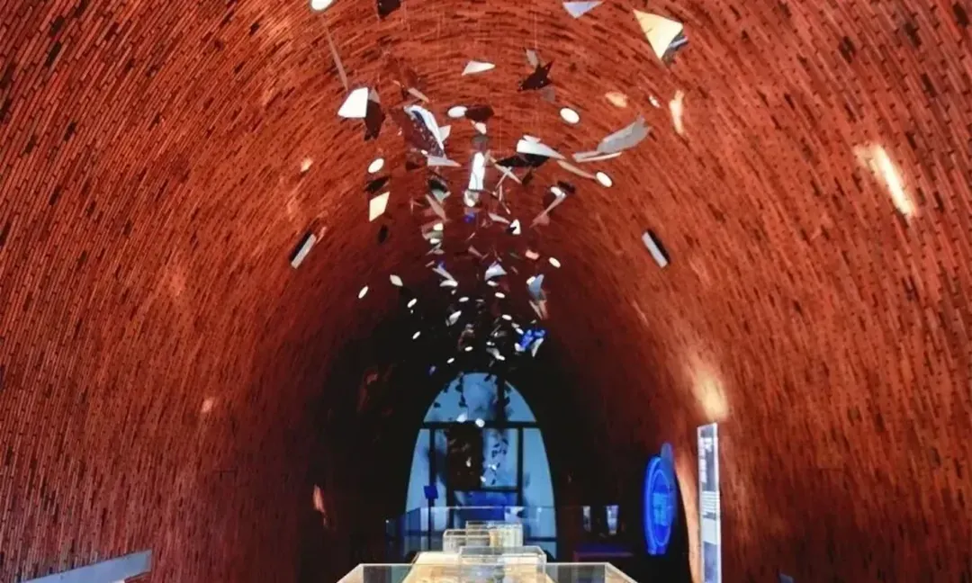 Inside a brick kiln in Jingdezhen, shards of porcelain hanging in the air of the museum built within it